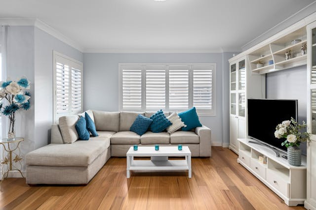 a blue and white living room with a large white couch